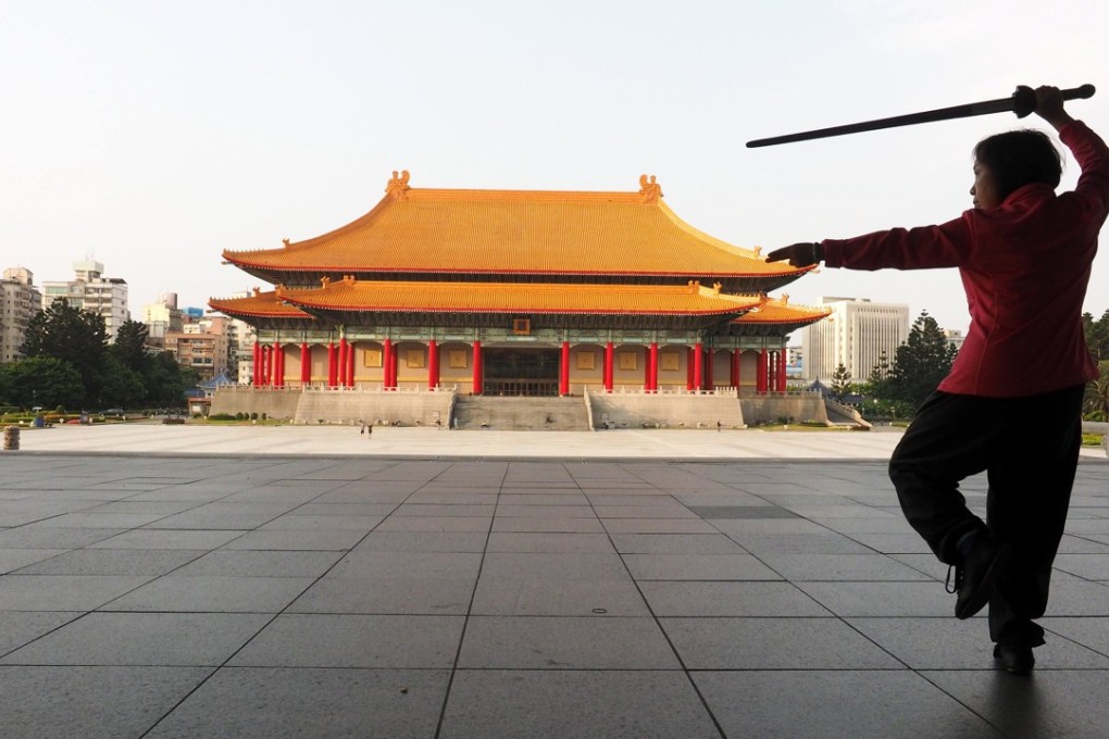 A woman practises tai chi in front of the National Theatre in Taipei in March. Taiwan must take steps to maintain its competitive edge in the face of rising China. Photo: EPA-EFE