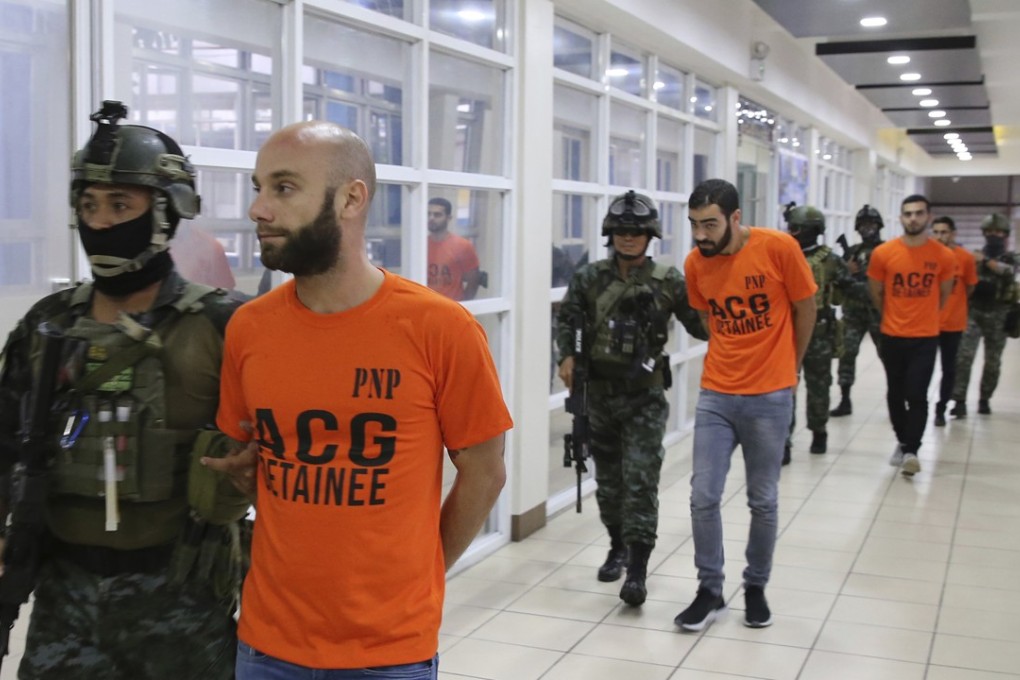 Philippine National Police, SAF (Special Action Force) members escort the Israeli nationals after the raid. Photo: AP