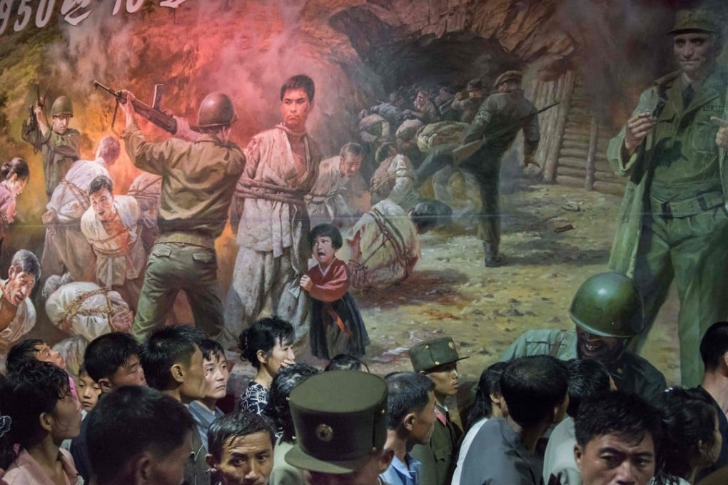 North Korean visitors walk past a painting showing US soldiers preparing to kill North Koreans at the Sinchon Museum of American War Atrocities. Photo: AFP