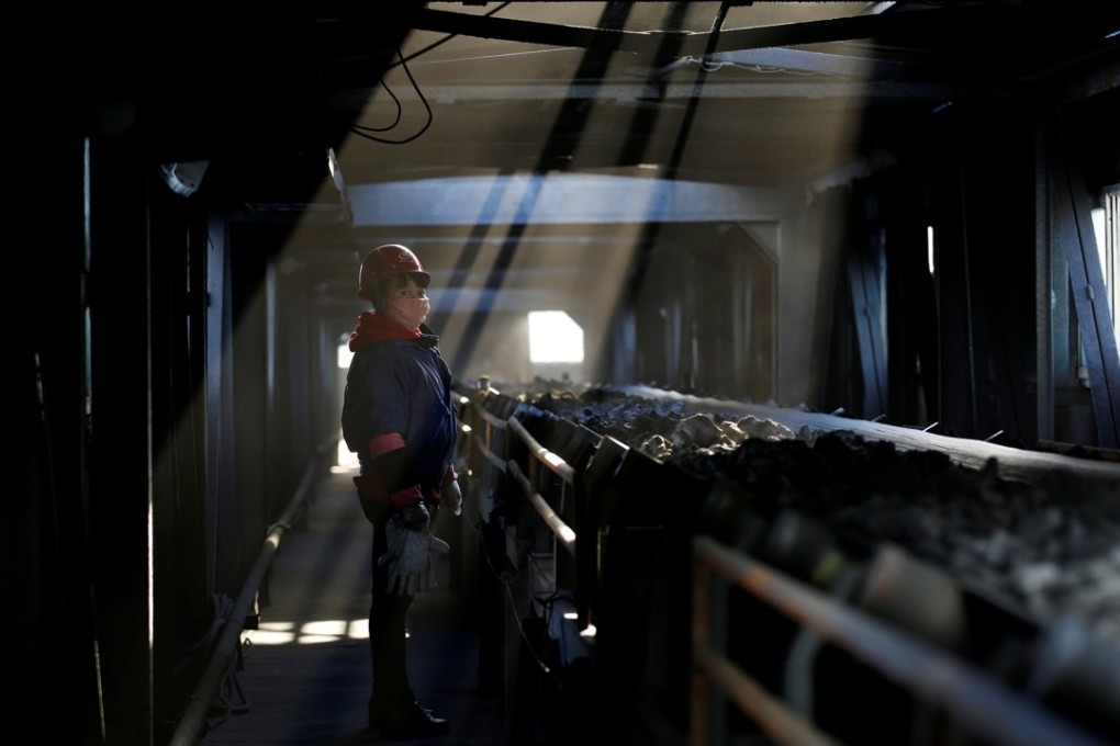 A worker inspects a conveyor belt carrying coal at a coal coking plant. Leiyang’s once lucrative coal industry has been shrinking since 2012. Photo: Reuters