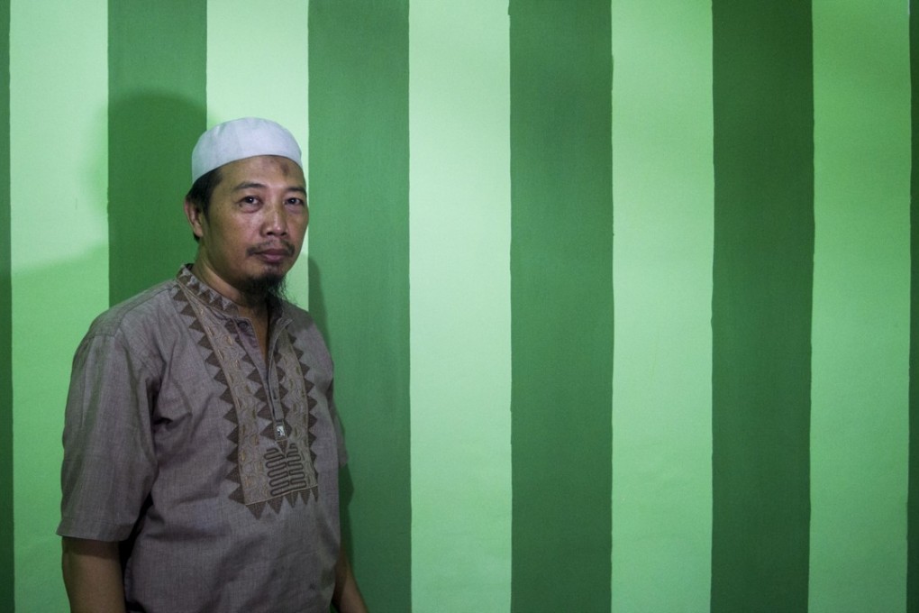 Pak Hidayat, husband and father of four, at his house in Surabaya’s northern district of Krembangan. Photo: Fully Syafi