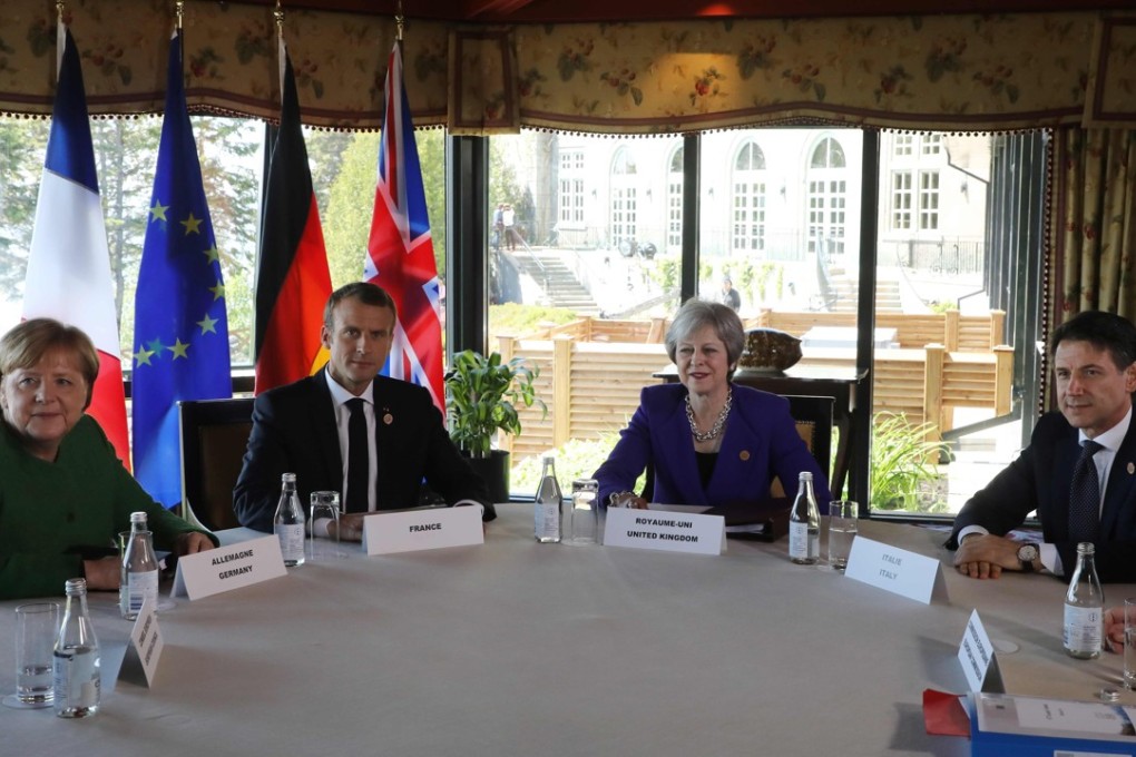Left to right: German Chancellor Angela Merkel, French President Emmanuel Macron, British Prime Minister Theresa May, and Italian Prime Minister Giuseppe Conte meet at the G7 summit in La Malbaie, Quebec, on Friday. Photo: pool via AFP