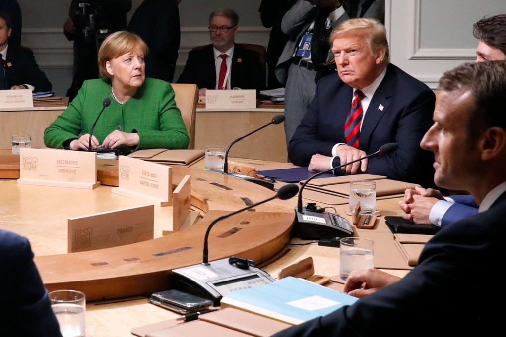 German Chancellor Angela Merkel looks over at US President Donald Trump as they meet Canadian Prime Minister Justin Trudeau, French President Emmanuel Macron and the other leaders during the G7 summit on Friday. Photo: Reuters
