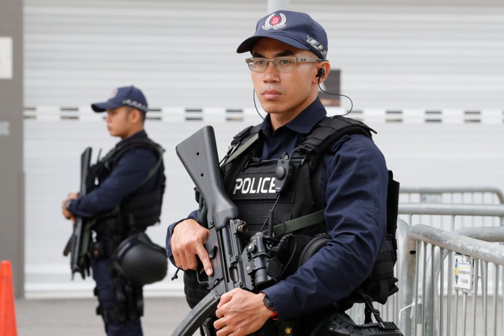Singaporean policemen stand guard at a media centre for the summit. Photo: Reuters