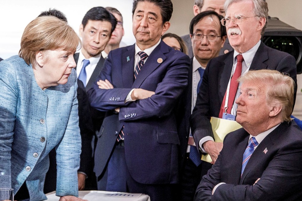German Chancellor Angela Merkel speaks to U.S. President Donald Trump during the second day of the G7 meeting in Charlevoix city of La Malbaie, Quebec, Canada, June 9, 2018. Bundesregierung/Jesco Denzel/Handout via REUTERS ATTENTION EDITORS – THIS IMAGE WAS PROVIDED BY A THIRD PARTY. NO RESALES. NO ARCHIVES. TPX IMAGES OF THE DAY
