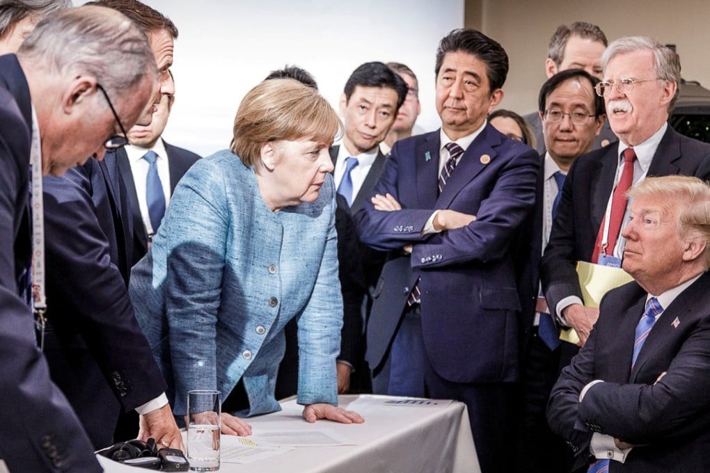 German Chancellor Angela Merkel speaks to US President Donald Trump during the second day of the G7 meeting in Canada on Saturday. Photo: German government handout via Reuters