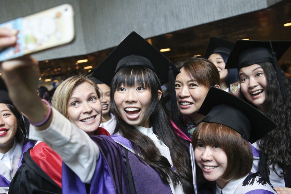Students take a selfie during their graduation ceremony at the Hong Kong Academy for Performing Arts in Wan Chai last year. Photo: SCMP / Sam Tsang