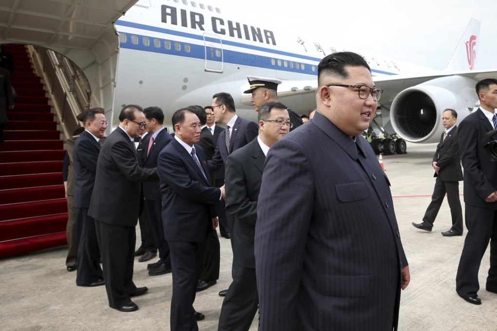 North Korean leader Kim Jong-un, right, arrives at the Changi International Airport on Sunday. Photo: Ministry of Communications and Information of Singapore via AP