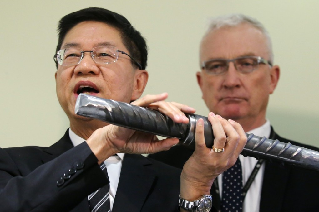 Philco Wong Nai-keung (left), MTR Corp projects director, demonstrates how a steel rebar is attached to a coupler, during a press conference on the Sha Tin to Central rail link, at the MTR headquarters in Kowloon Bay on June 6. Photo: Dickson Lee