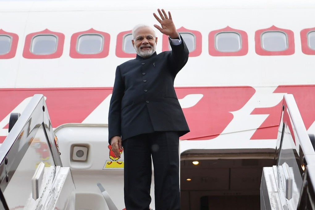 Indian Prime Minister Narendra Modi waves before boarding an aircraft as he departs from Qingdao on June 10, after attending the annual Shanghai Cooperation Organisation summit. Photo: AFP