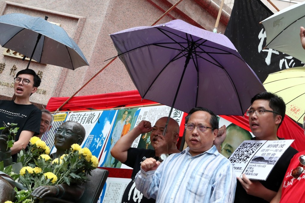 Leung Kwok-hung (left), Avery Ng, chairman of the League of Social Democrats, Albert Ho, president of Hong Kong Alliance in Support of Patriotic Democratic Movements in China, and “Bull” Tsang Kin-shing, attend the unveiling of the Liu Xiaobo statue in Times Square, Causeway Bay. Photo: K.Y. Cheng