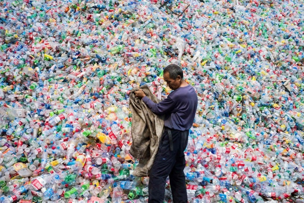 A Chinese labourer sorts plastic bottles for recycling in a village on the outskirts of Beijing, in September 2015. For years the world’s top destination for recyclables, China banned 24 types of solid waste imports from January 2018. Photo: AFP