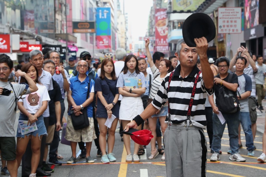 Street performer Andrew So, aka Mr Funny, performs at Sai Yeung Choi Street South in Mong Kok on June 3. Photo: K.Y. Cheng