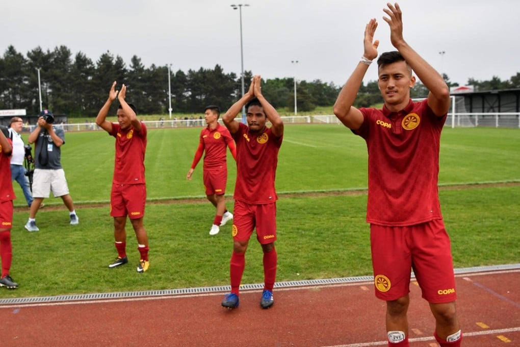 Tibet players applaud after the full-time whistle of the loss to Abkhazia. Photo: AFP