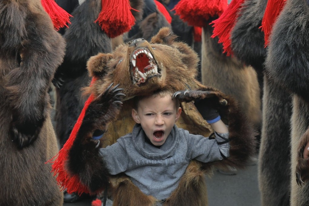 A child wears a bear costume as part of a new year ritual in Comanesti, northern Romania, on December 30, 2017. Slowing macroeconomic indicators, rising interest rates and political uncertainty have prompted warnings that a bear market may be about to bite investors. Photo: AP