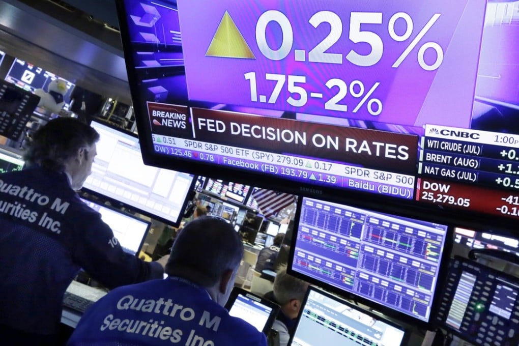 A television screen on the floor of the New York Stock Exchange shows the rate decision of the US Federal Reserve on Wednesday. Photo: AP