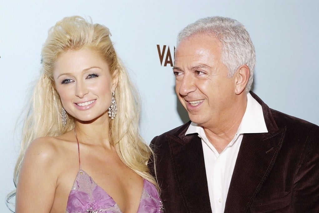 In this file photo taken on October 18, 2004, model Paris Hilton poses with fashion designer and Guess co-founder Paul Marciano in Hollywood in 2004. Photo: Agence France-Presse