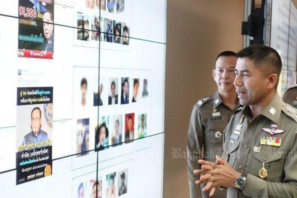 Deputy Tourist Police chief Surachate 'Big Joke' Hakparn shows media his briefing board to press charges against a London-based Facebook user for spreading 'fake news' on the satellite plans (top) and an 'altered photo' of Prime Minister Prayut Chan-o-cha. Photo: Bangkok Post