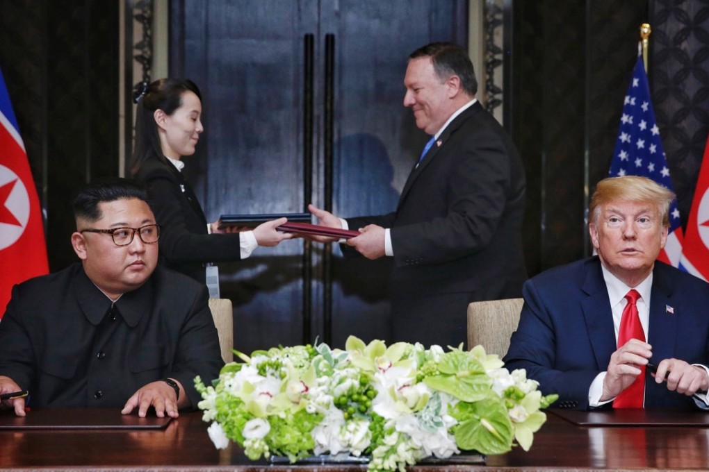 Kim Jong-un and Donald Trump wait while a document is exchanged between US Secretary of State Mike Pompeo and the North Korean leader's sister, Kim Yo-jong, in Singapore on Tuesday. Photo: The Straits Times via EPA-EFE