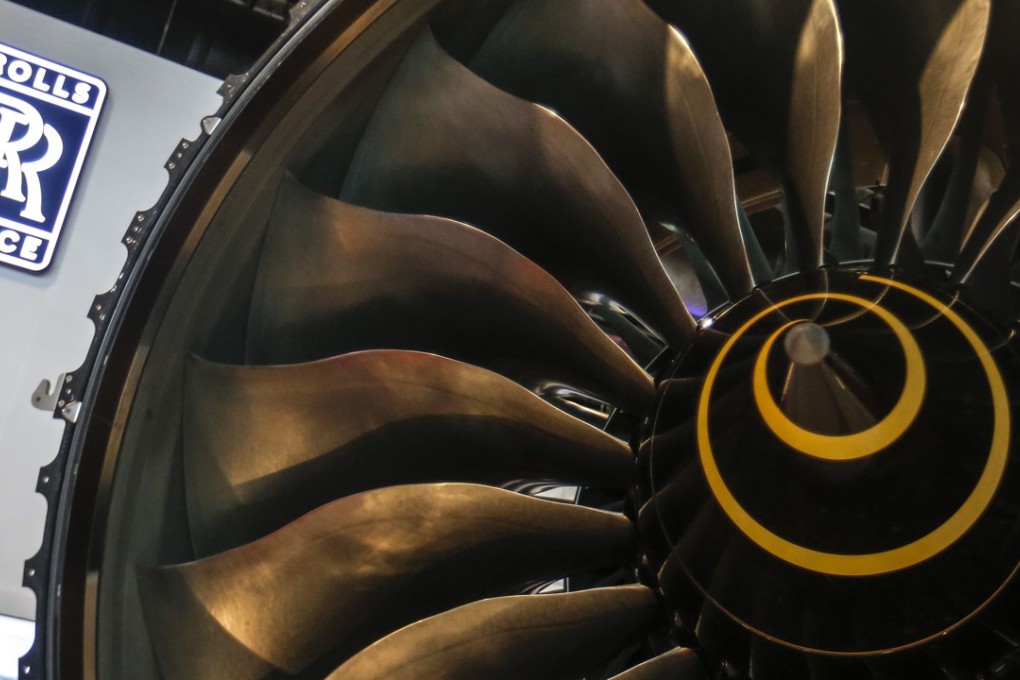 Rolls Royce logo displayed above a Trent 1000 turbofan engine at the Singapore Air Show. A former Rolls-Royce chief combustion technologist, was arrested after the security services received intelligence that classified information may have been passed to Beijing. Photo: EPA