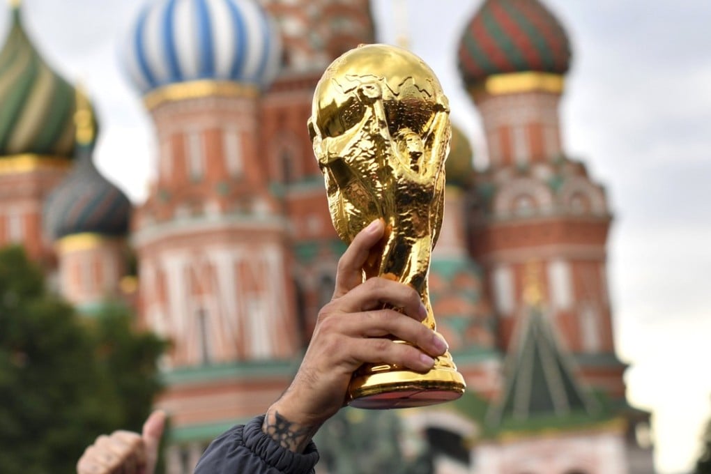 Colombian fans hold a fake trophy in front Saint Basil’s Cathedral on the Red Square in Moscow. Photo: AFP