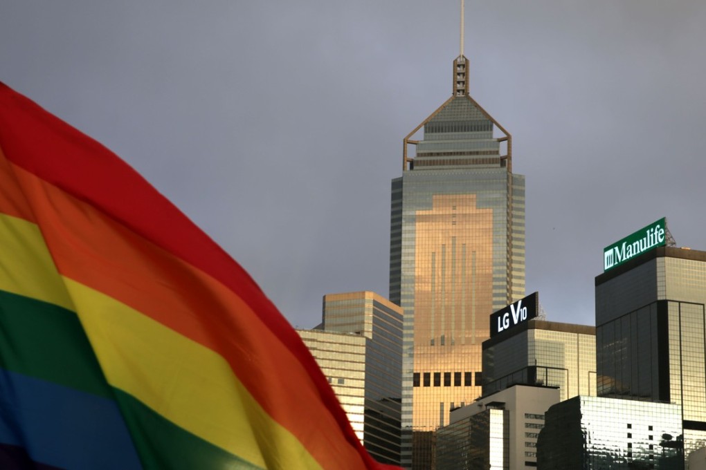 A rainbow flag, a symbol of the LGBT community, flutters against the skyline of the central business district in Hong Kong, on November 6, 2015. Protesters marched in the city’s annual gay pride parade on the day to call for equality and same-sex marriage. Photo: AFP