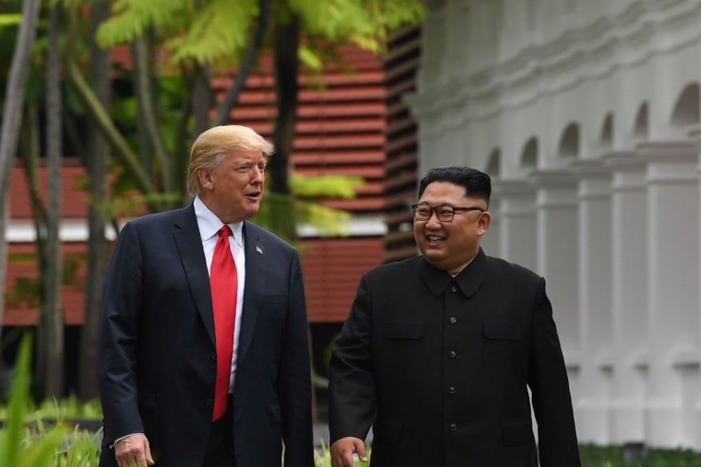 North Korean leader Kim Jong-un walks with US President Donald Trump during a break in talks at the historic summit between their two countries, in Singapore on June 12. Photo: AFP