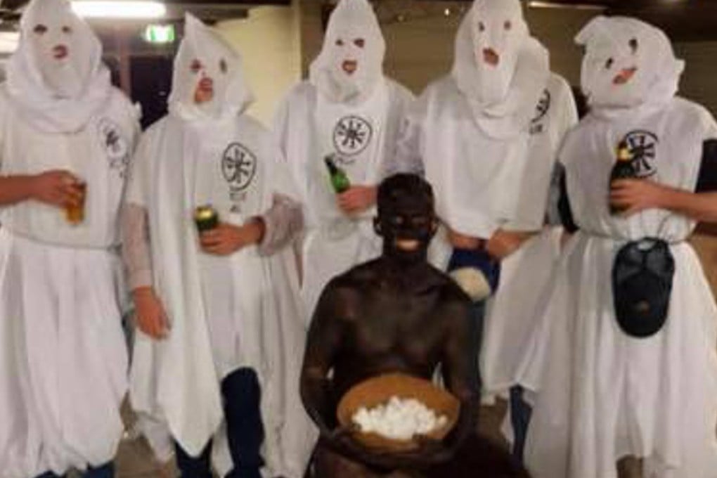 Charles Sturt University students dressed as Klansmen and their black slave for a 'politically incorrect' end-of-term party. Photo: Instagram