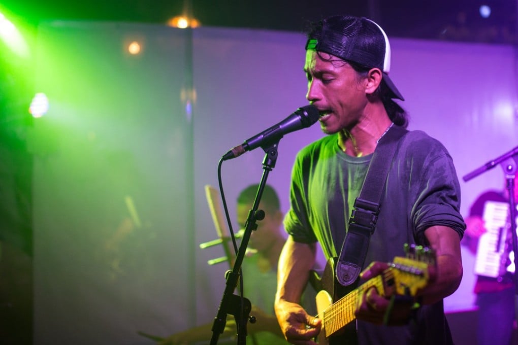 Singer and guitarist Uk Sochiet of Kampot Playboys on stage in the Cambodian capital Phnom Penh. Photo: Steve Porte