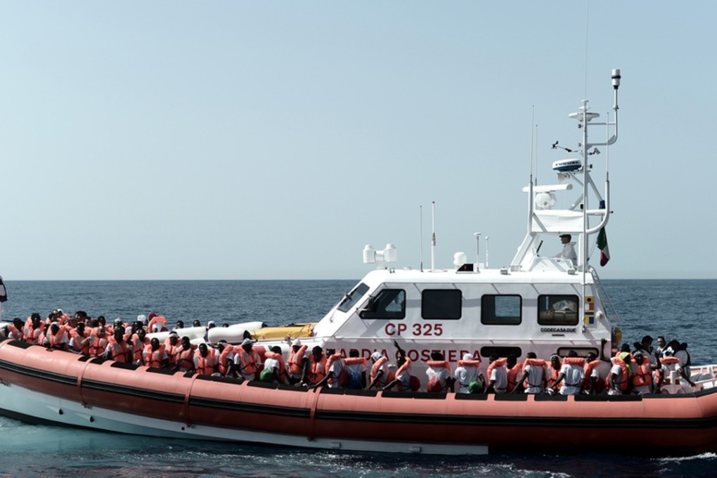 Migrants aboard an Italian coastguard ship en route to Spain, after the new Italian government refused them safe port in a dramatic bid to force Europe to share the burden of unrelenting arrivals. Photo: AFP/Handout