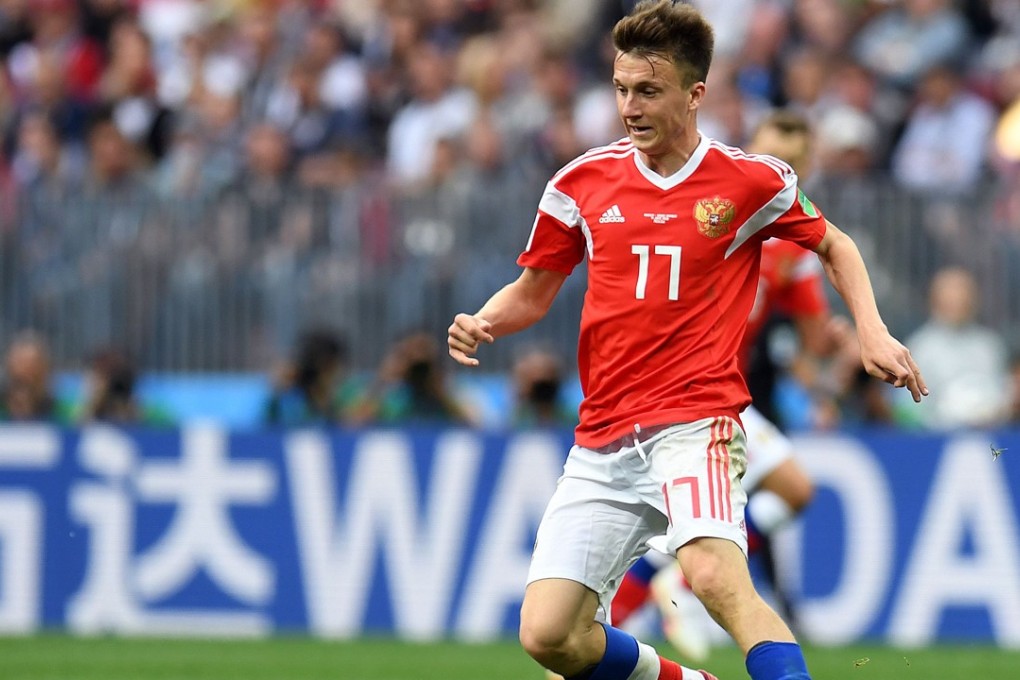 Russia midfielder Aleksandr Golovin controls the ball against Saudi Arabia. Chinese company Wanda’s brand was advertised pitchside. Photo: AFP
