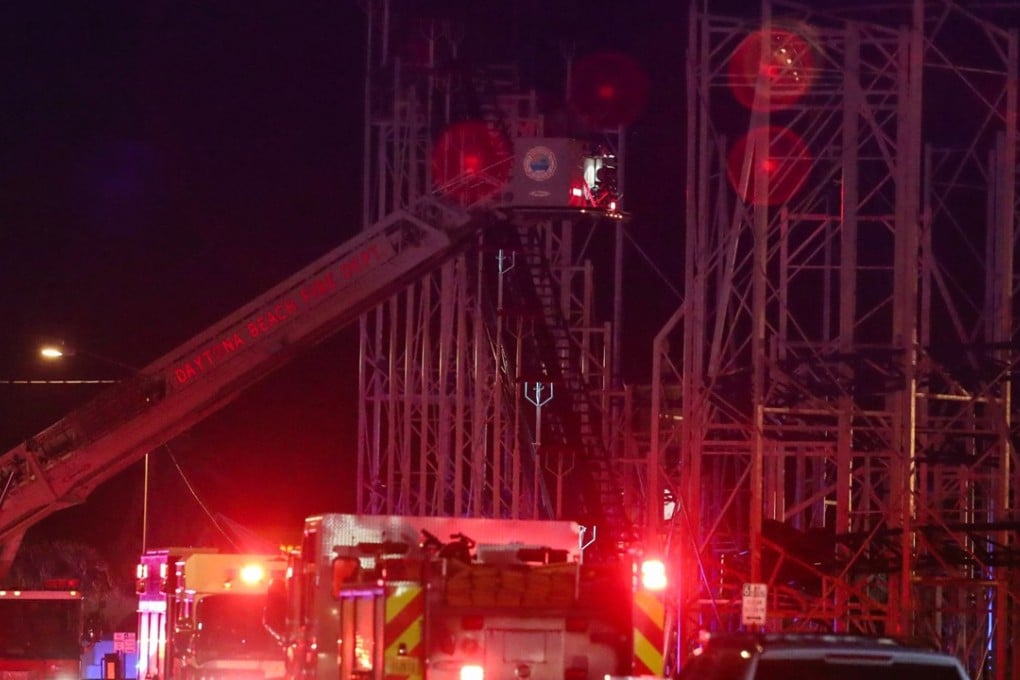 A Daytona Beach Fire Department ladder is extended over a roller coaster that derailed on Thursday night, injuring several riders. Photo: The Daytona Beach News-Journal via AP