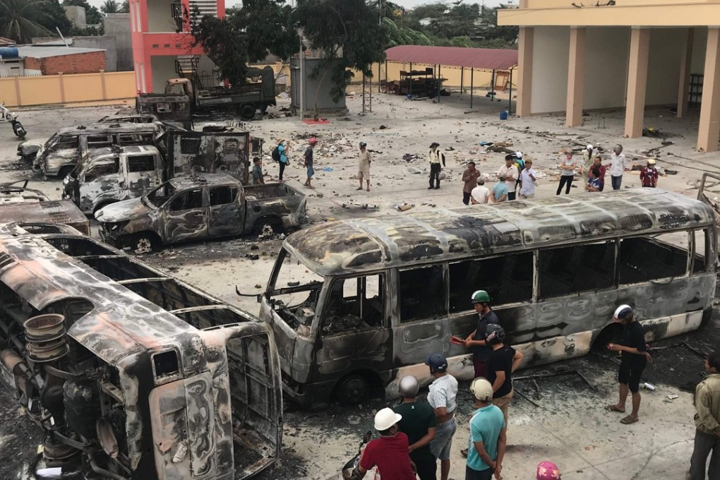 Charred buses at a police station compound in central Binh Thuan province. Photo: AFP