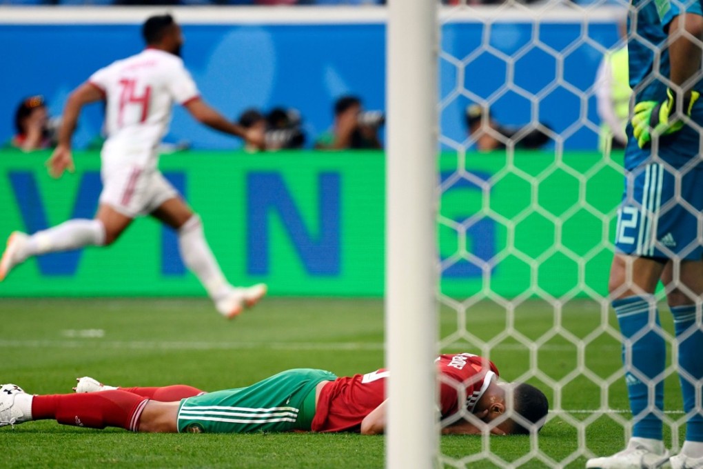 Morocco’s Aziz Bouhaddouz reacts after scoring an own goal that cost his team a point in their group B opener against Iran. Photo: AFP