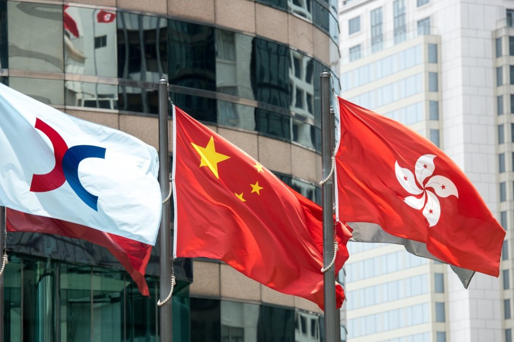 The Hong Kong stock exchange flag (L) flies alongside the flags of China and Hong Kong. Photo: SCMP