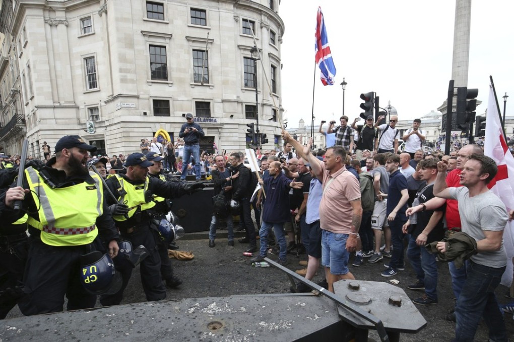 British police confront supporters of right-wing activist Tommy Robinson during a protest in Trafalgar Square, London. Photo: AP