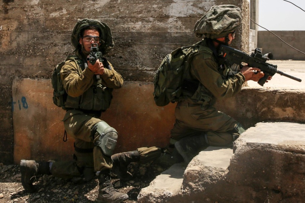 Israeli soldiers take position during clashes with Palestinian protesters in the village of Kfar Qaddum, near Nablus in the occupied West Bank. Photo: AFP