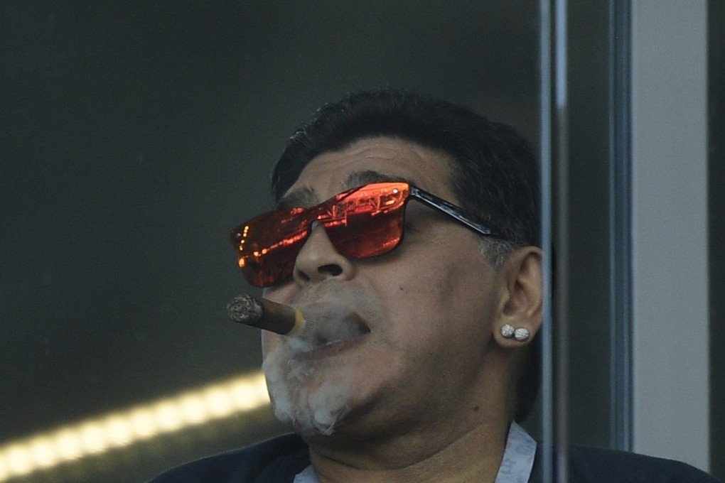 Argentina's football legend Diego Maradona smokes a cigar at the Russia 2018 World Cup group D match between Argentina and Iceland. Photo: AFP