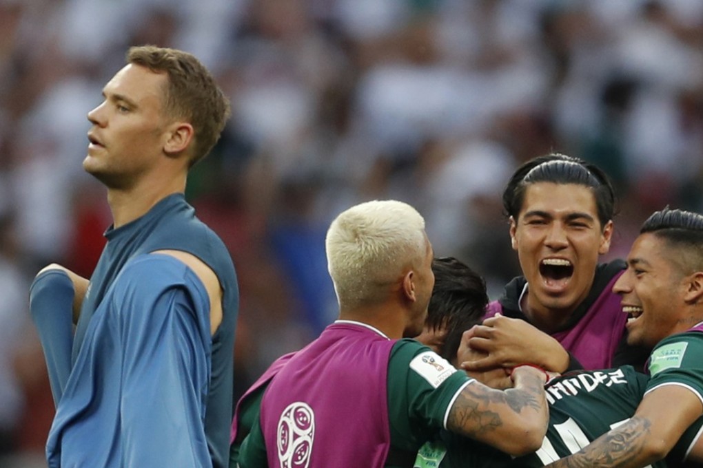 Germany goalkeeper Manuel Neuer walks past celebrating Mexico players. Photo: AP
