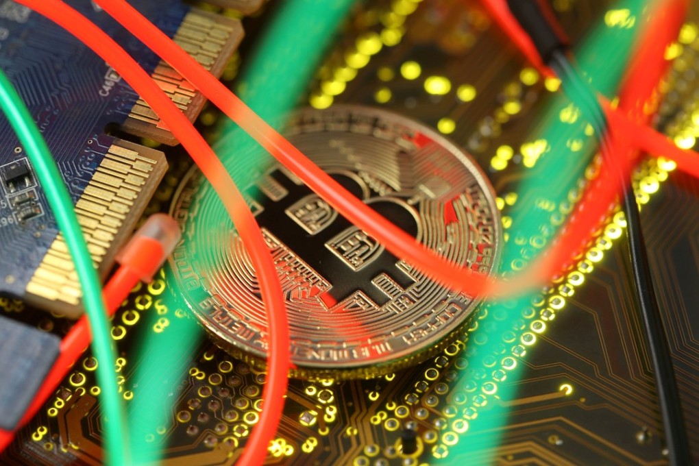 A representation of the Bitcoin virtual currency is seen on a PC motherboard in this file photograph. Photo: Reuters