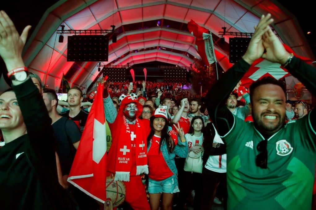 Fans of the Swiss soccer team (seen at a public viewing area at Turbinenplatz Square) celebrate after their team drew against Brazil on Sunday. Photo: Reuters