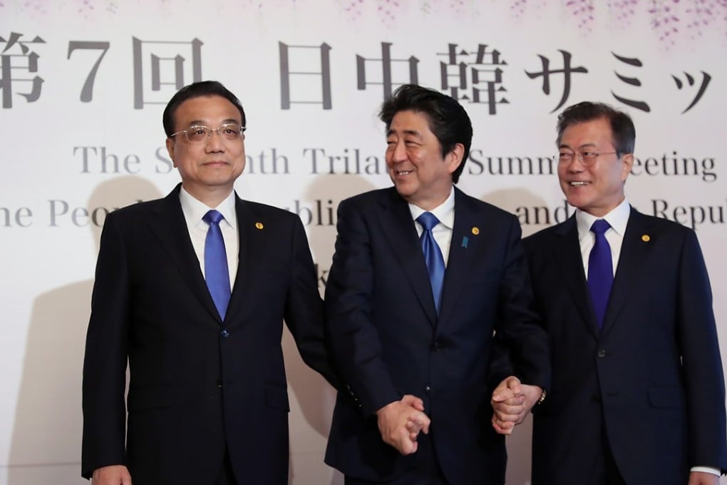 Chinese Premier Li Keqiang (left), Japanese Prime Minister Shinzo Abe (centre), and South Korean President Moon Jae-in pose for photographers before the 2018 Japan-China-South Korea Trilateral Summit in Tokyo, Japan, on May 9. Photo: EPA