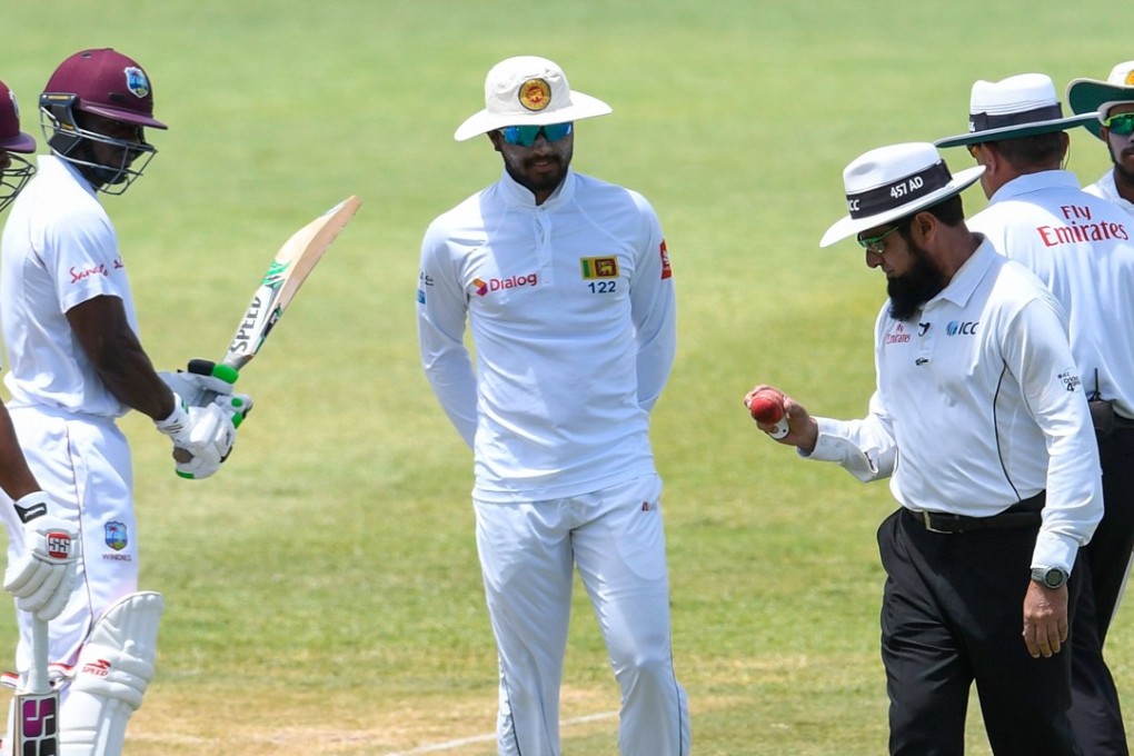 Umpire Aleem Dar examines the ball as Sri Lanka captain Dinesh Chandimal looks on during the second test in Gros Islet, St Lucia. Photo: AFP