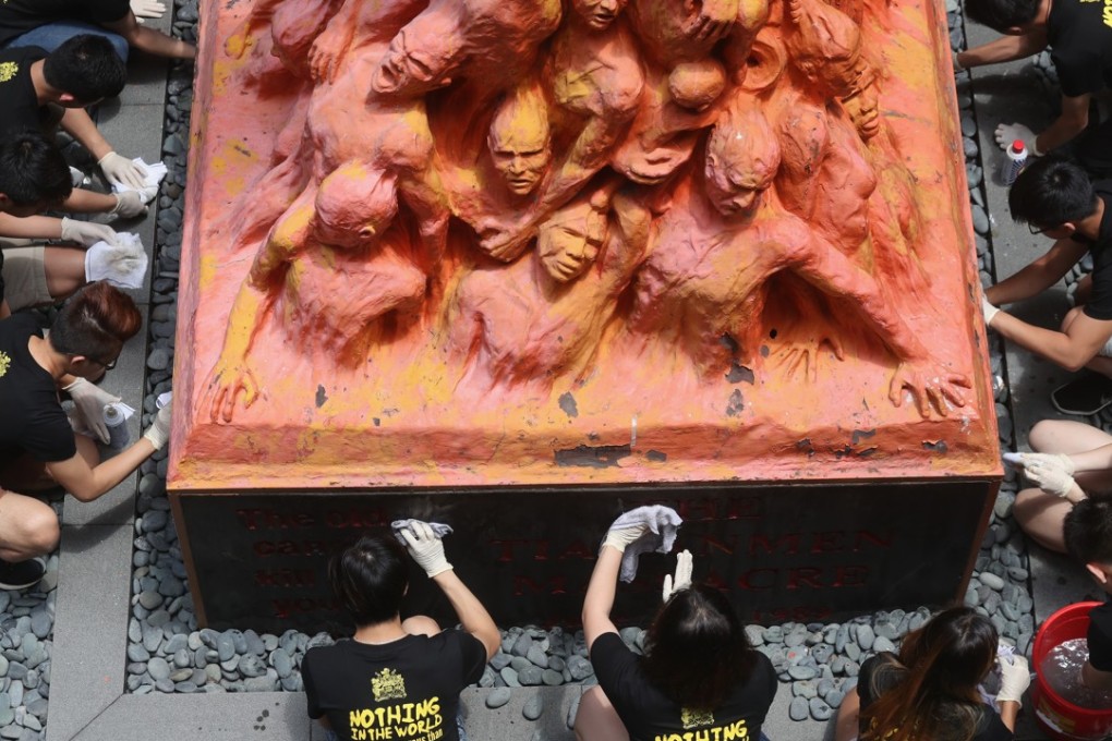 Members of the University of Hong Kong’s student union clean the Pillar of Shame commemorating the Tiananmen crackdown, in Pok Fu Lam on June 4. However, Hong Kong’s eight student unions boycotted the Victoria Park vigil on the day, suggesting it was irrelevant to locals. Photo: K. Y. Cheng