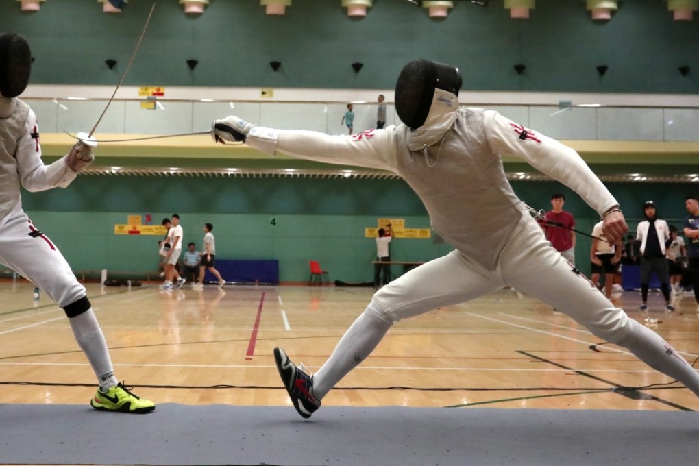 Cheung Siu-lun (right) on the attack against Ryan Choi at the President's Cup at the Hong Kong Park Sports Centre. Choi won the bout, clinching the final spot in the Asian Games team. Photo: Jonathan Wong