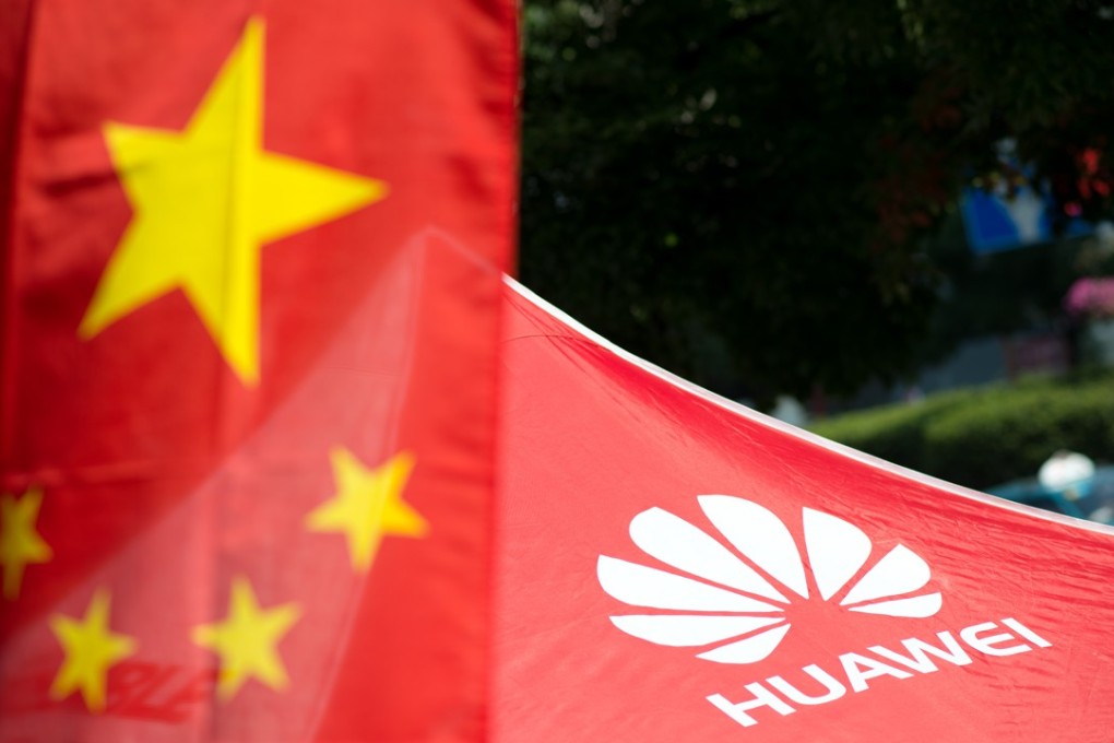 The logo of Huawei Technologies next to a Chinese flag in Shanghai, amid rising China trade tensions. Photo: AFP