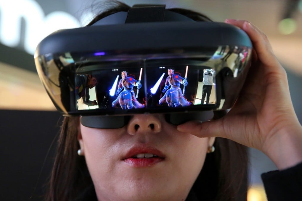 A woman wears a virtual reality headset while playing ‘Star Wars: Jedi Challenges’ game at the Mobile World Congress in Barcelona in February, 2018. Photo: Bloomberg