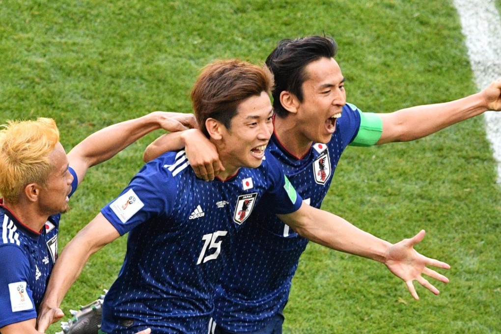 Japan's forward Yuya Osako (15) celebrates with Yuto Nagatomo and captain Makoto Hasebe after scoring against Colombia. Photo: AFP