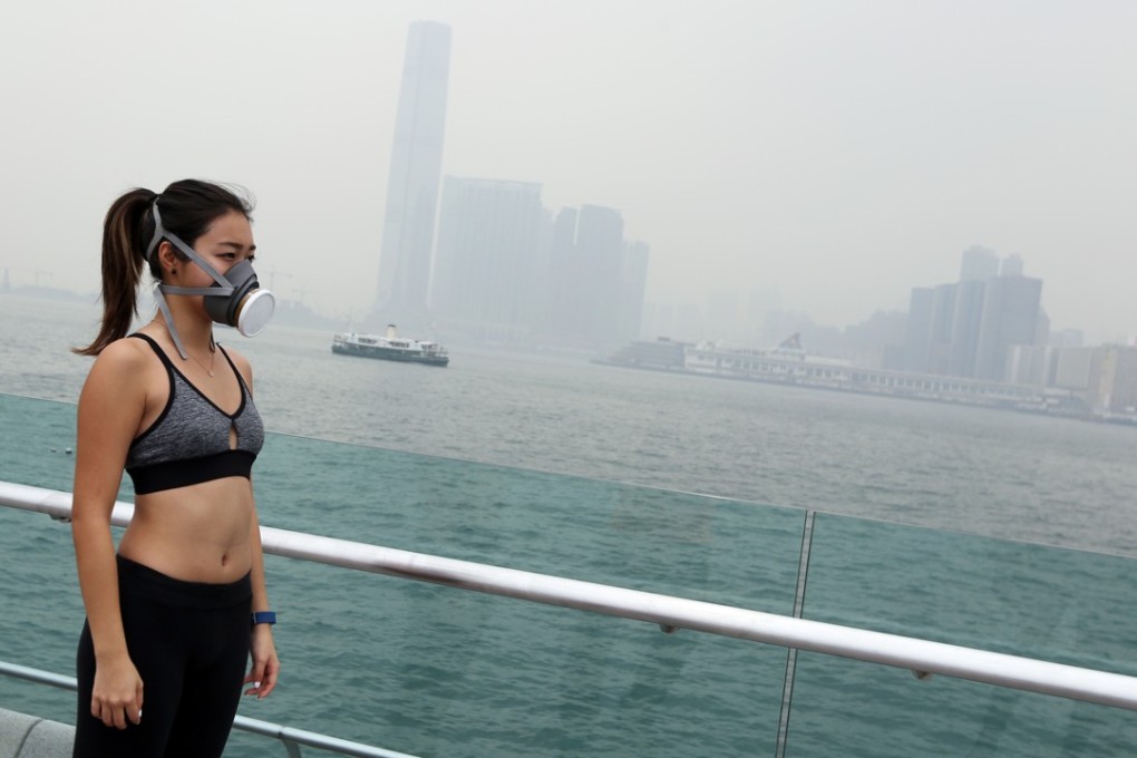 A woman running with a mask on a polluted day in Hong Kong. Photo: Xiaomei Chen