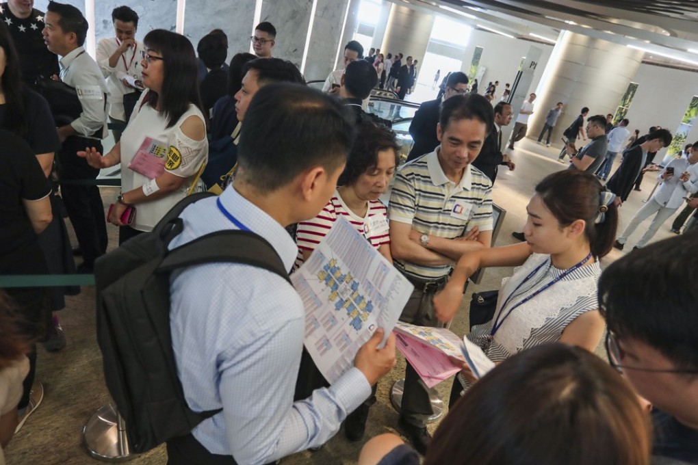 Buyers queue up for a property launch in Hong Kong. Between 2,000 and 2,500 apartments are expected to be sold in June. Photo: Jonathan Wong